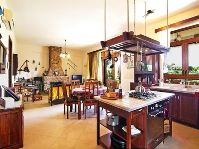 a kitchen with a stove and a dining room at Holiday home with pool in Kalamítsion Alexándrou