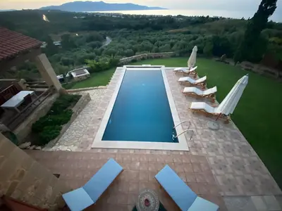 an overhead view of a swimming pool with lounge chairs at ARIALKiS - ΑΡΙΑΛΚίΣ in Plataniás