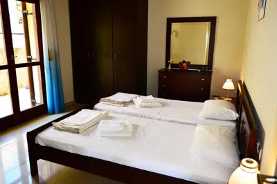 a bedroom with two beds with towels on them at Villa Spilia Homeleader in Spiliá