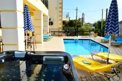 a swimming pool with two chairs and a swimming pool at Villa Spilia Homeleader in Spiliá