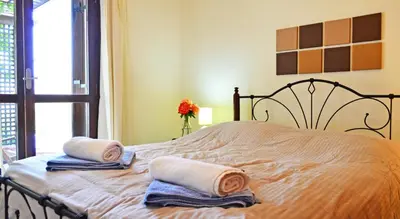 a bedroom with a bed with towels and a window at Villa Ravdoucha Homeleader in Ravdhoúkha