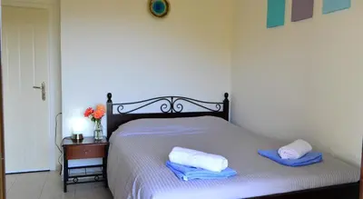 a bedroom with a bed with two towels on it at Villa Ravdoucha Homeleader in Ravdhoúkha