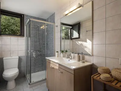 a bathroom with a toilet and a sink and a shower at Villa Hibiscus in Spiliá