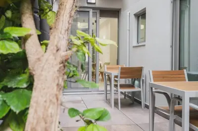 a patio with tables and chairs in a building at Peris 1 - Central Apt near Old Town with Parking in Chania Town