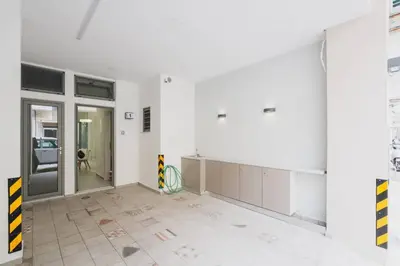 an empty room with white walls and a large glass door at Peris 1 - Central Apt near Old Town with Parking in Chania Town