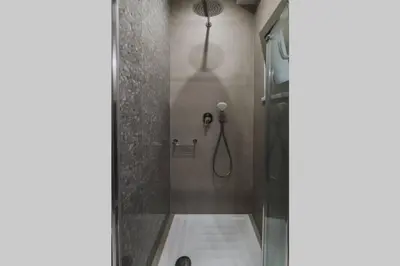 a bathroom with a shower with a glass door at Peris 1 - Central Apt near Old Town with Parking in Chania Town