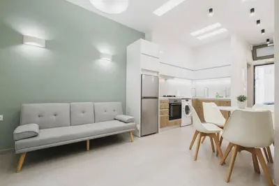 a living room with a couch and a table and chairs at Peris 1 - Central Apt near Old Town with Parking in Chania Town
