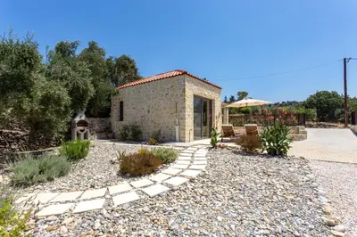 a stone house with a garden and a driveway at Canna Villa in Vamos