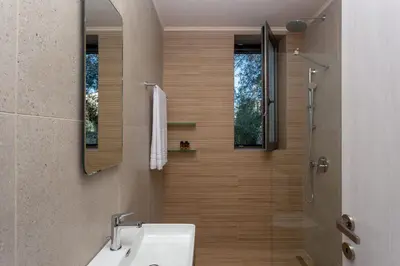 a bathroom with a sink and a shower at Canna Villa in Vamos