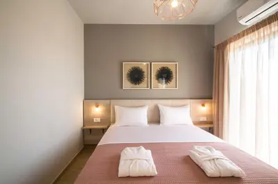 a bedroom with a bed with two white towels on it at Mike's apartment I Luxury above the sea in Kissamos