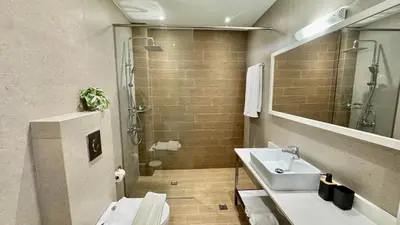 a bathroom with a sink and a shower at Mike's apartment I Luxury above the sea in Kissamos
