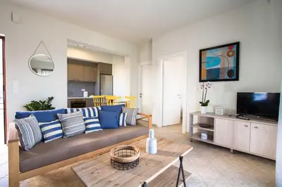 a living room with a couch and a table at Mike's apartment I Luxury above the sea in Kissamos