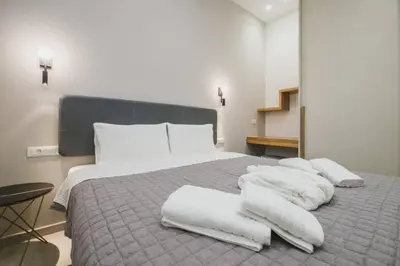a bedroom with a bed with white towels on it at Peris 2 - Central Apt near Old Town - AC, Washer in Chania Town