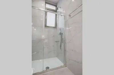 a bathroom with a shower with a glass door at Peris 2 - Central Apt near Old Town - AC, Washer in Chania Town