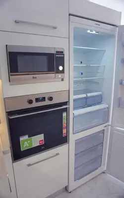 a refrigerator with its door open and a microwave at New Big Modern City Center Apartment in Chania Town