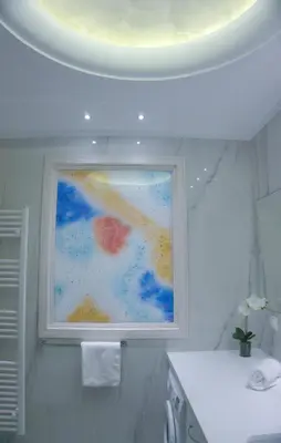 a bathroom with a large painting on the wall at New Big Modern City Center Apartment in Chania Town