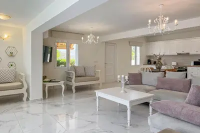 a living room with a couch and a table at Pano Stalos Villas in Stalos