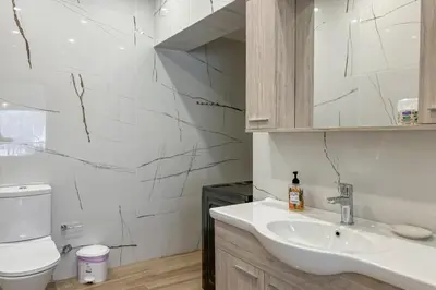a bathroom with a sink and a toilet at Pano Stalos Villas in Stalos