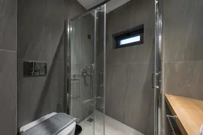 a bathroom with a shower with a glass shower stall at MIRMA CITY Old Town in Chania Town