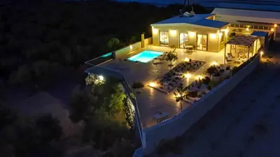 an aerial view of a house with a pool at night at 2 steps Falasarna beach-Liakos- Homeleader in Falasarna