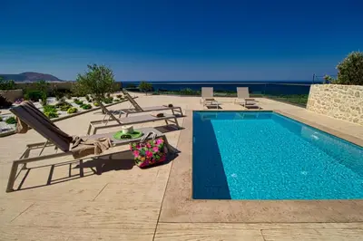 a swimming pool with chaise lounges next to a swimming pool at 2 steps Falasarna beach-Liakos- Homeleader in Falasarna