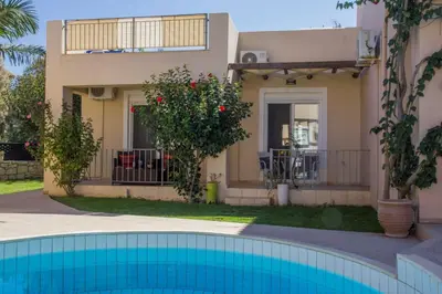 a villa with a swimming pool in front of a house at Villa Nopigia Homeleader in Nopíyia