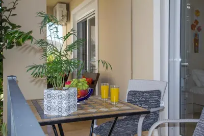 a table with a bowl of fruit and glasses of orange juice at Villa Nopigia Homeleader in Nopíyia