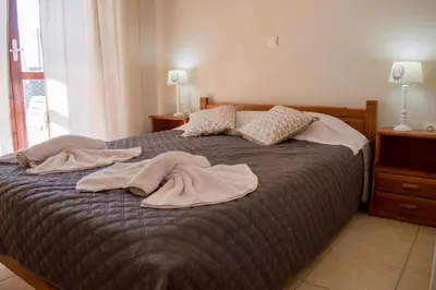a bedroom with a bed with towels on it at Villa Darmarohori Homeleader in Darmarochori