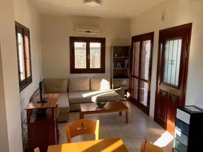 a living room with a couch and a table at Villa Darmarohori Homeleader in Darmarochori