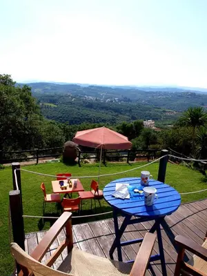 a blue table and chairs on a wooden deck at Villa Papoura Homeleader in Delimanolianá