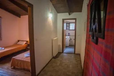 a small room with a bed and a hallway at Villa Papoura Homeleader in Delimanolianá