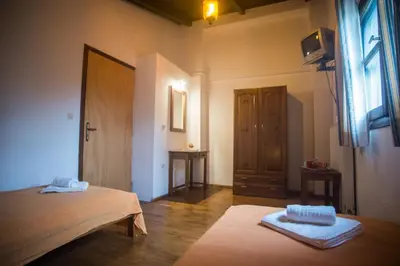 a room with a bed and a window and a door at Villa Papoura Homeleader in Delimanolianá