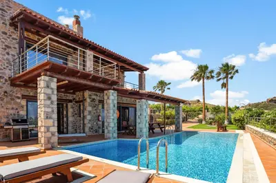 a villa with a swimming pool and a house at Kambos Horizon & Paradise Villas in Kissamos