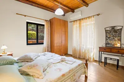 a bedroom with a large bed and a piano at Kambos Horizon & Paradise Villas in Kissamos