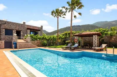 a swimming pool in front of a villa at Kambos Horizon & Paradise Villas in Kissamos