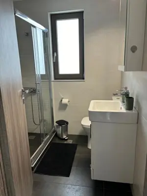 a bathroom with a toilet and a sink and a window at zonapartments A sea view-city center in Chania Town