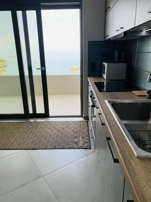 a kitchen with a sink and a large window at zonapartments A sea view-city center in Chania Town