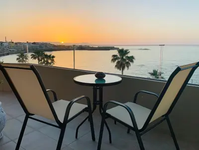 a table and chairs on a balcony with a view of the ocean at zonapartments A sea view-city center in Chania Town