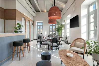 a dining room with a table and chairs at Malmo Historic Hotel in Chania Town