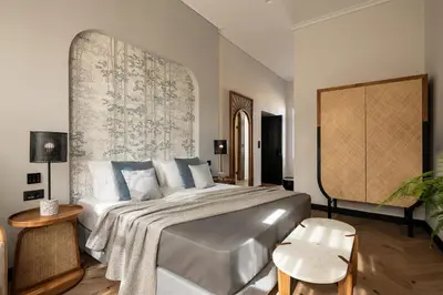a bedroom with a large bed with a large wall at Malmo Historic Hotel in Chania Town