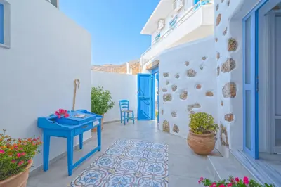 a blue table on a balcony with a blue door at Veranta Luxury Suite in Khóra Sfakíon