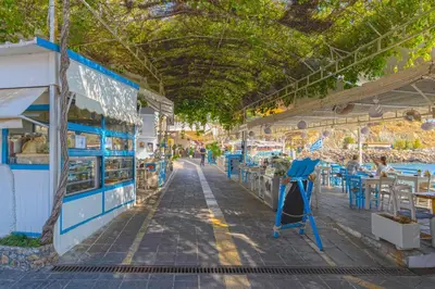 a market with tables and chairs and a ceiling at FantaSea Luxury Suite in Khóra Sfakíon