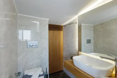 a bathroom with a white tub and a sink at Regal Residence in Chania Town