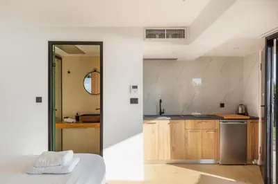 a kitchen with white walls and wooden cabinets at Regal Residence in Chania Town