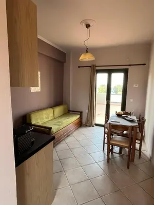 a living room with a couch and a table at Girogiali Apts in Kissamos