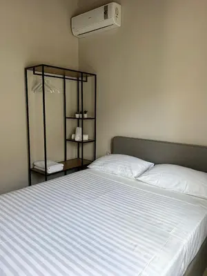 a bedroom with a large bed with a white bedspread at Serenity Resort in Vrísai