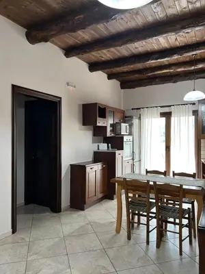 a kitchen and dining room with a table and chairs at Serenity Resort in Vrísai
