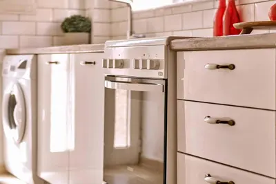a kitchen with a stove and a dishwasher at Natasha's Luxury apartment by the sea in Galatás