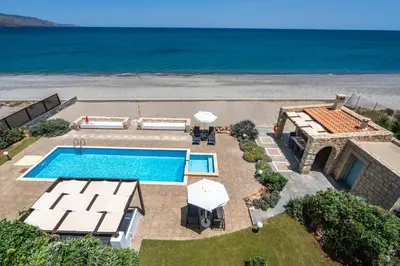 an aerial view of a villa with a swimming pool at Beachfront villa Turquoise with private pool, BBQ and ping pong table in Chania Town