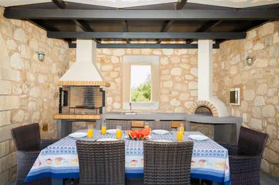 a dining room with a table and chairs at Beachfront villa Turquoise with private pool, BBQ and ping pong table in Chania Town
